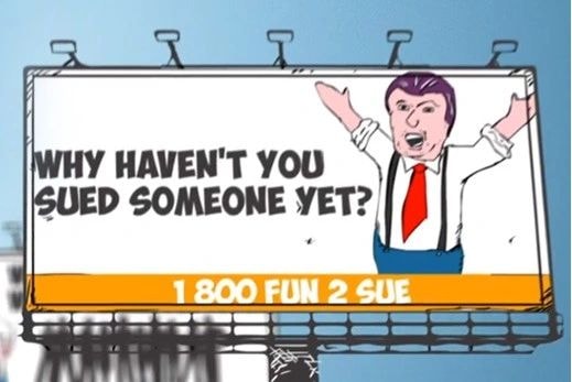 Humorous billboard: WHY HAVEN'T YOU SUED SOMEONE YET? 1 800 FUN 2 SUE