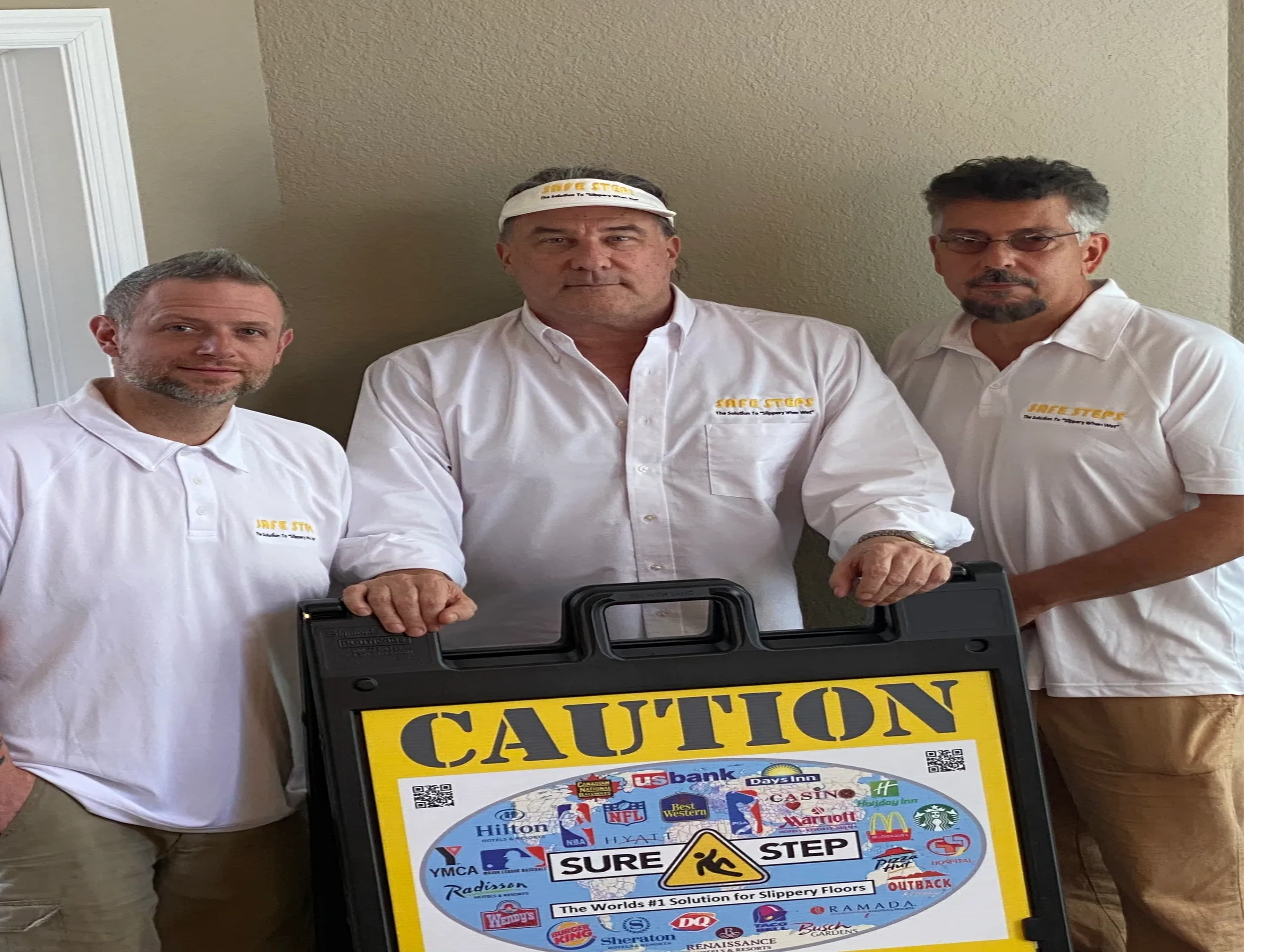 Florida Safe Steps team holding Sure Step caution display board